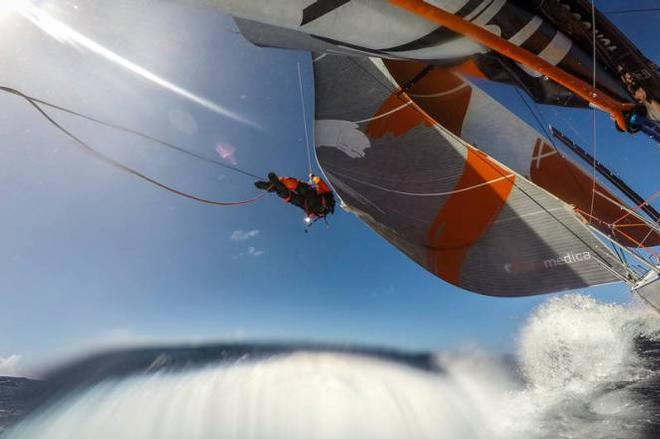 Onboard Team Alvimedica - Dave Swete swings out to the clew to adjust leech tension on the Frac - Leg five to Itajai - Volvo Ocean Race 2015 ©  Amory Ross / Team Alvimedica